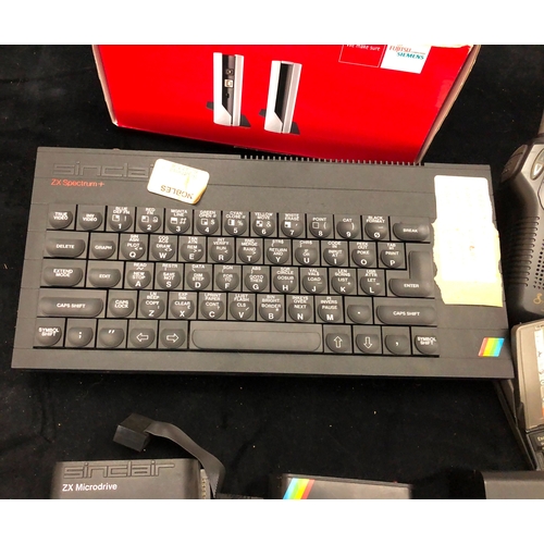 1082 - A Sinclair ZX Spectrum with a quantity of cables and cartridges, a Psion Series 5 pocket computer, a... 