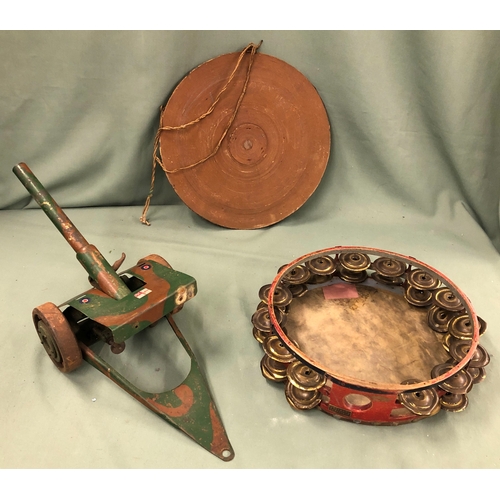 1085 - A vintage tambourine, 26cm diameter, a miniature dart board, 28.5cm diameter and a cast iron toy can... 