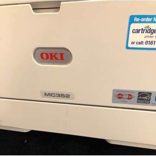 1092 - An Oki MC352 all in one printer and various printer cartridges (powers on).