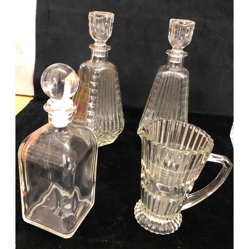 1094 - 12 various cut-glass decanters (2 stoppers missing) and 1 jug.