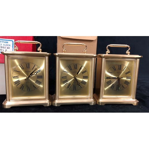 1100 - 4 Rhythm Quartz carriage style clocks (1 handle missing, 2 battery covers missing)