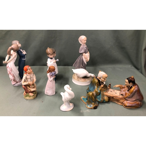 1120 - A Lladro group of a couple, IB-12J, 20cm high, a Lladro swan, 10cm high, a Noa group of 2 choristers... 