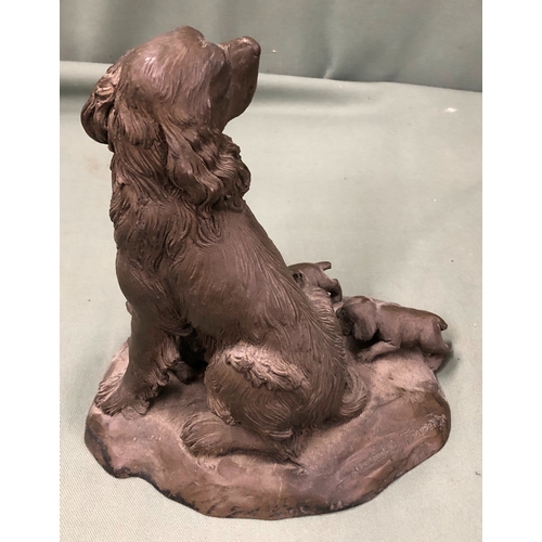 1149 - A resin figure of a Spaniel dog with 3 puppies, 18cm high