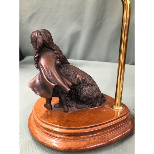 1154 - A table lamp with bronze effect resin figure of a dog and girl on wood base, 44cm high overall.