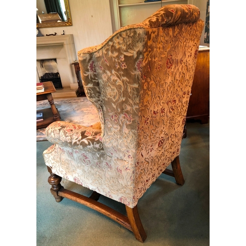 1166 - An oak framed upholstered wing back armchair, 80cm wide, 72cm deep, 117cm high. This item is not hel... 