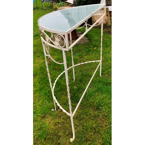 1183 - A semi-circular metal garden table with glass top, 75cm wide, 33cm deep, 73cm high. This item is not... 