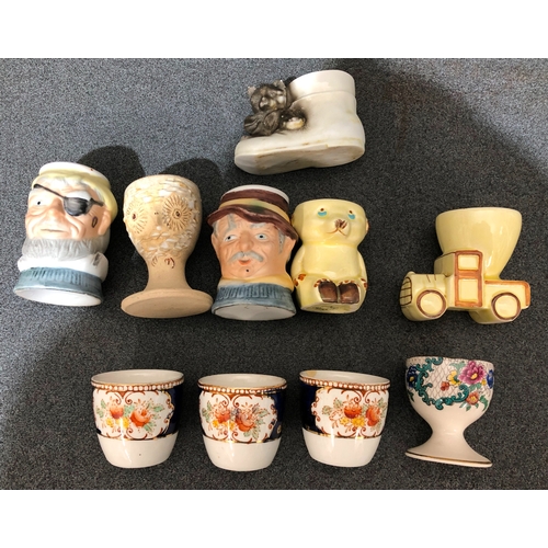 1198 - 10 various novelty and other egg cups.