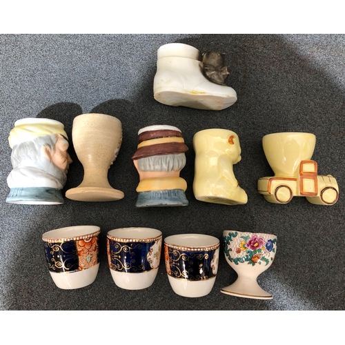 1198 - 10 various novelty and other egg cups.