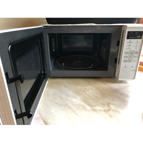 1233 - A Panasonic microwave, serial no. NN-E27JWM, 43cm wide, 30cm deep, 25.5cm high.  This item is not he... 