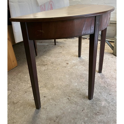 1259 - A demi lune mahogany table 105cm wide, 48cm deep, 71cm high (1 leg repaired and loose, water stain a... 