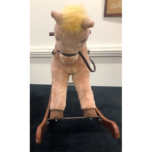 1011 - A Lefray Designs Ltd plush rocking horse on wood base, 65cm high overall.