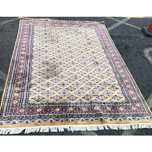 1017 - A modern Persian rug on yellow/mustard and beige ground, 273 x 188cm.