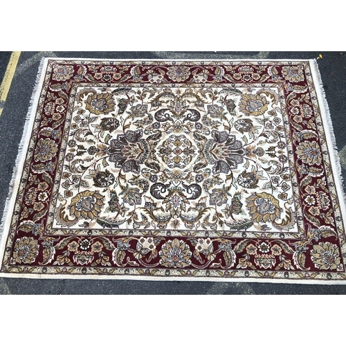 1018 - A modern hand knotted Indian rug on red and cream ground, 241 x 310cm.