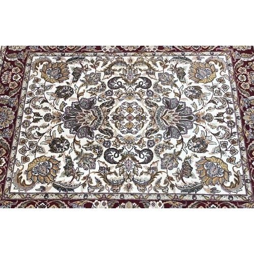 1018 - A modern hand knotted Indian rug on red and cream ground, 241 x 310cm.