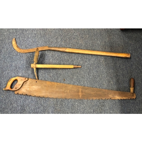 1038 - A large vintage 2-handled saw, 120cm long, a scythe and a pickaxe.