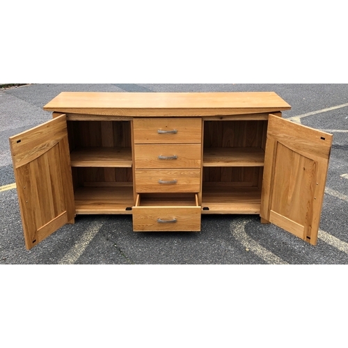 1057 - JB Global light oak sideboard with 4 drawers, 2 panel doors enclosing 1 adjustable shelf to each sid... 