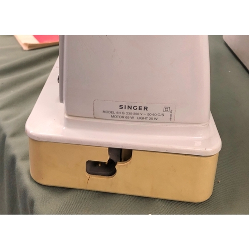 1074 - A Singer 611 G sewing machine with power cable, pedal and manual, in hard carrying case.