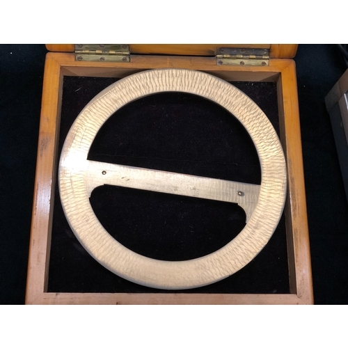 1080 - A brass J Casartelli full circle brass protractor in wood case, a Zero Settings Air meter in wood ca... 