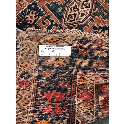 1164 - A woven rug, 183cm long, 113cm wide (generally worn, tassels and 1 corner worn away, repaired tear t... 