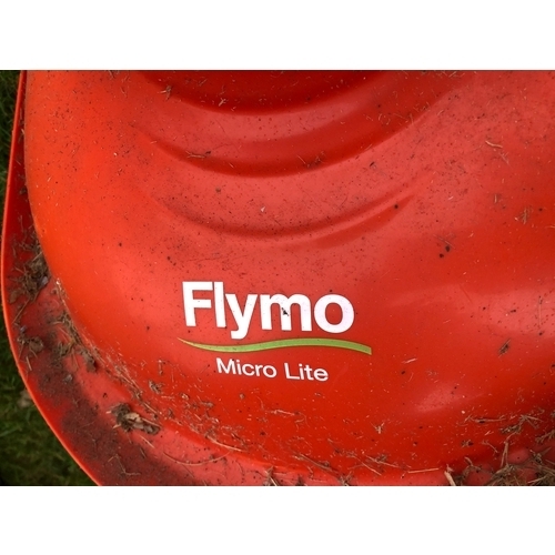 1236 - A Flymo Micro Lite electric mower and a Qualcast electric scarifier. This item is not held by PF Win... 