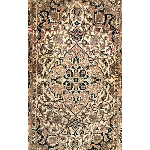 1325 - A Persian rug with centre medallion (faded) 207 long, 136cm wide