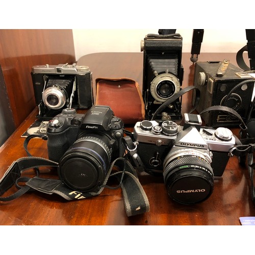 1328 - A large quantity of cameras, including an Olympus OM-2, Pentax P50, Yashica Zoomtec 90, Dacora, Brow... 