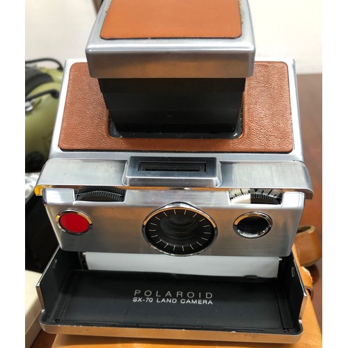 1343 - A Polaroid SX-70 land camera in leather Polaroid case, a Canon Eos 750 camera with 35-70mm lens, cas... 