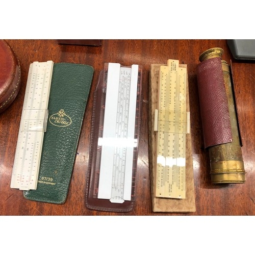 1351 - A quantity of various slide rules, 2 vintage measuring tapes, a protractor set etc.