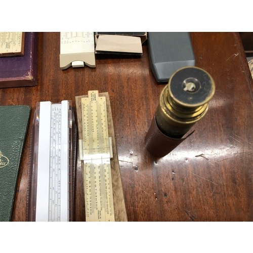 1351 - A quantity of various slide rules, 2 vintage measuring tapes, a protractor set etc.