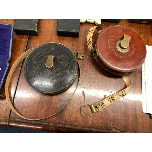 1351 - A quantity of various slide rules, 2 vintage measuring tapes, a protractor set etc.