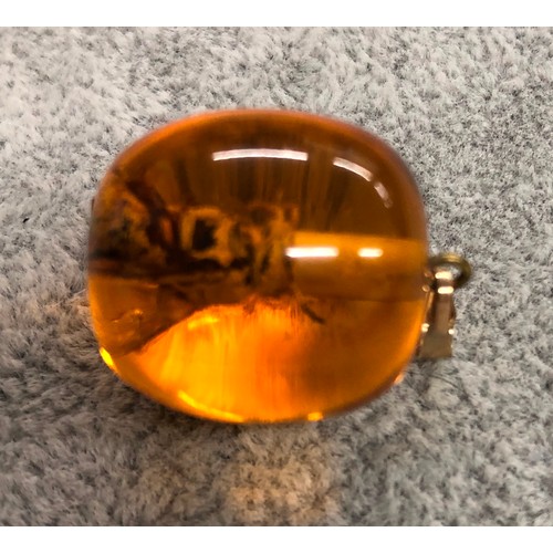 1273 - An amber resin pendant with wasp inside, 3cm long.