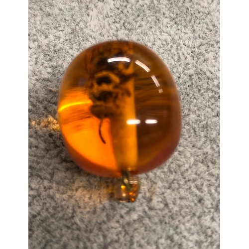 1273 - An amber resin pendant with wasp inside, 3cm long.