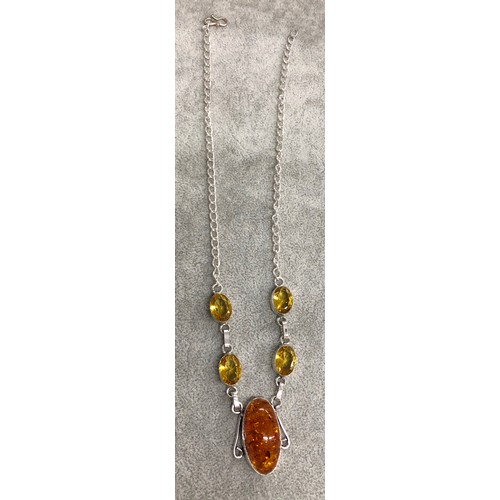 1278 - A silver-coloured necklace with central amber resin drop stone with 4 Citrine style stones above, 3.... 