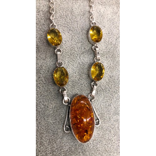 1278 - A silver-coloured necklace with central amber resin drop stone with 4 Citrine style stones above, 3.... 