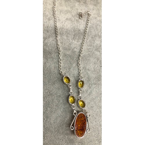 1278 - A silver-coloured necklace with central amber resin drop stone with 4 Citrine style stones above, 3.... 