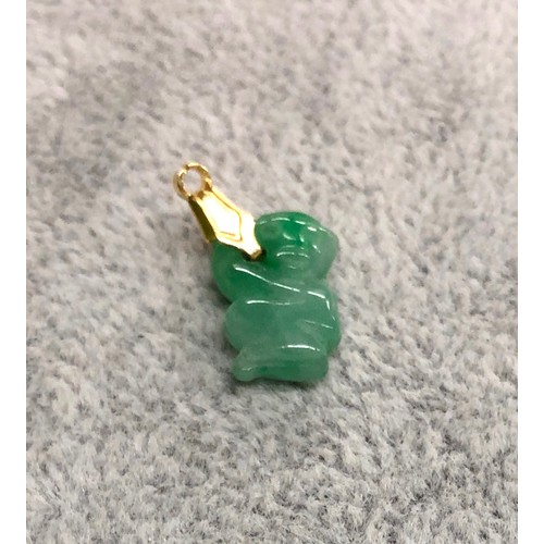 1285 - A green jade style monkey shaped pendant, 1.5cm long.