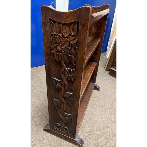 1139 - An oak bookcase with carved detail to sides, 67cm wide, 28.5cm deep overall, 75cm high.