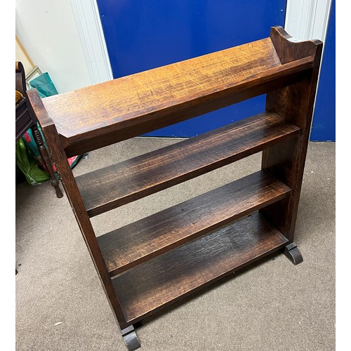 1139 - An oak bookcase with carved detail to sides, 67cm wide, 28.5cm deep overall, 75cm high.