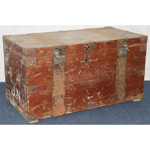 984 - A rectangular wood trunk with metal bandings and corners, large carrying handles, hinged lid enclosi... 