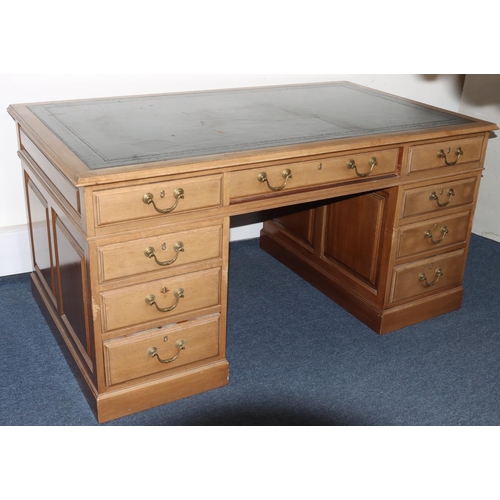 991 - A mahogany kneehole pedestal desk having black leather inset top, centre drawer flanked by 8 short g... 