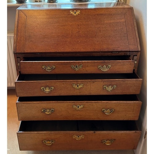 1398 - A George III oak bureau, good condition, but no keys, and a brass handle missing from one of the dra... 