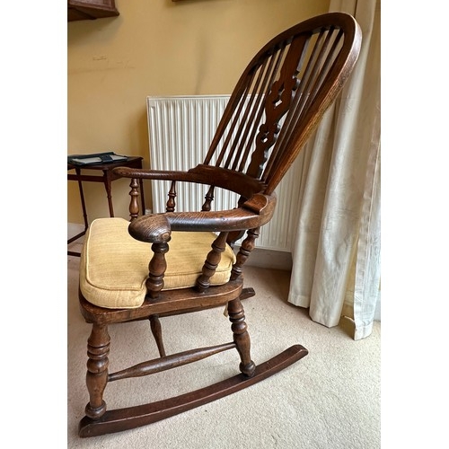 1403 - An oak rocking chair in very good condition, with cushion, 64cm wide, 70cm deep, 101cm high. This it... 