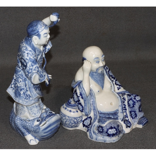 157 - 2 Oriental blue and white china figures of  a gentleman standing on a toad, 29.5cm high and a seated... 