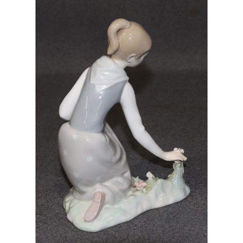 162 - A Lladro figure of a kneeling young lady picking encrusted flowers, 21cm high