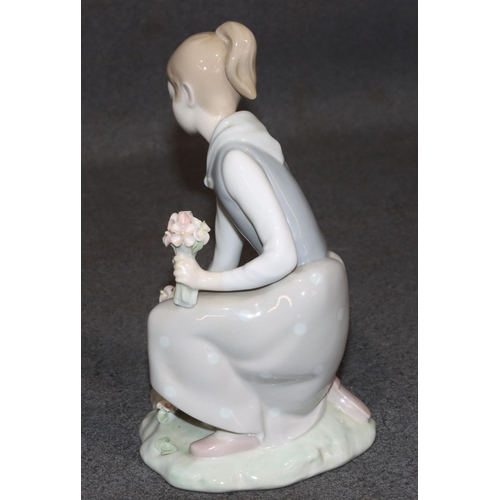 162 - A Lladro figure of a kneeling young lady picking encrusted flowers, 21cm high