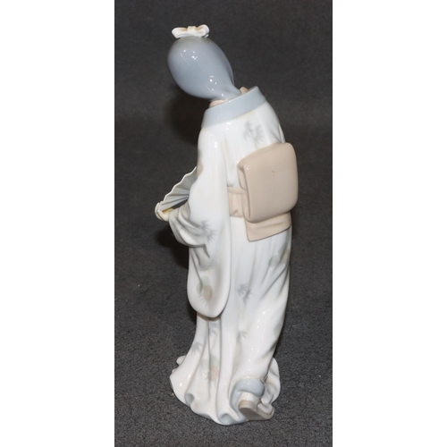 163 - A Nao figure of an Oriental standing lady holding a fan, 26cm high