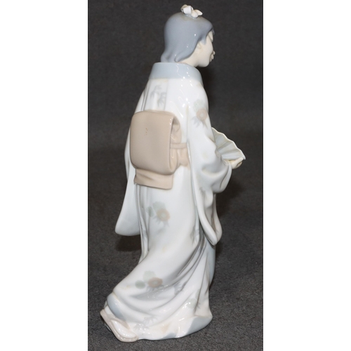 163 - A Nao figure of an Oriental standing lady holding a fan, 26cm high