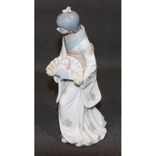 163 - A Nao figure of an Oriental standing lady holding a fan, 26cm high