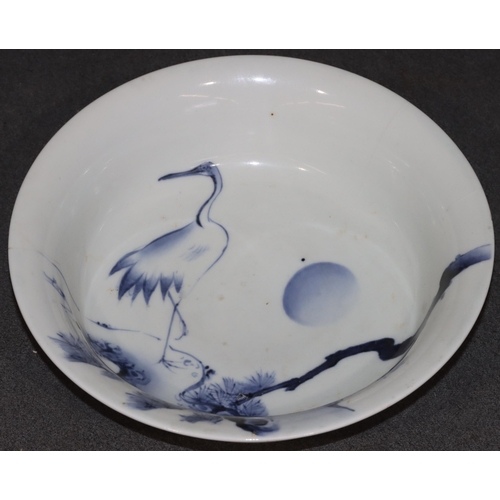 169 - An Oriental blue and white round trumpet shaped bowl depicting stork, floral and branch decoration, ... 