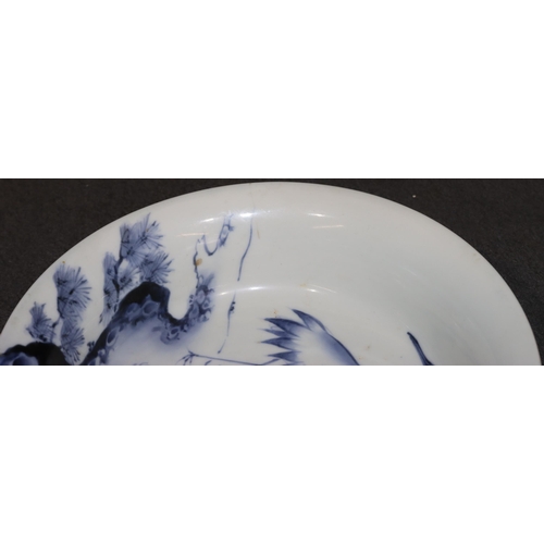 169 - An Oriental blue and white round trumpet shaped bowl depicting stork, floral and branch decoration, ... 